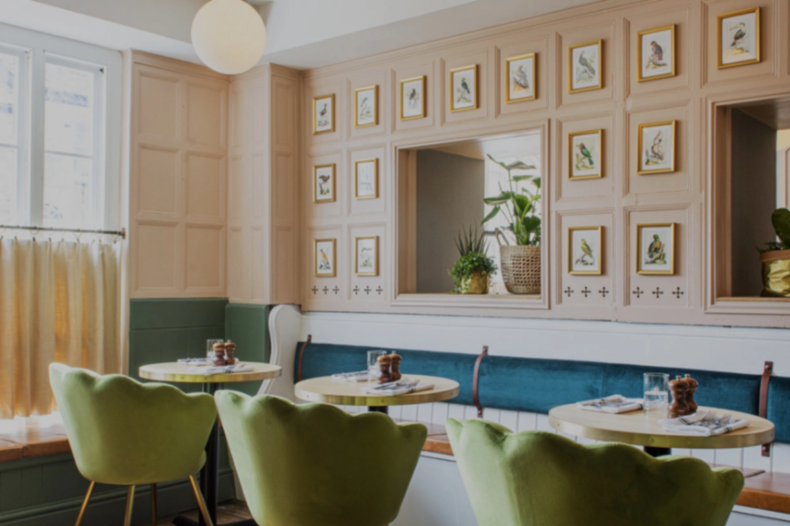 The Longstore Lemon Street — panelled dining room with green velvet chairs.